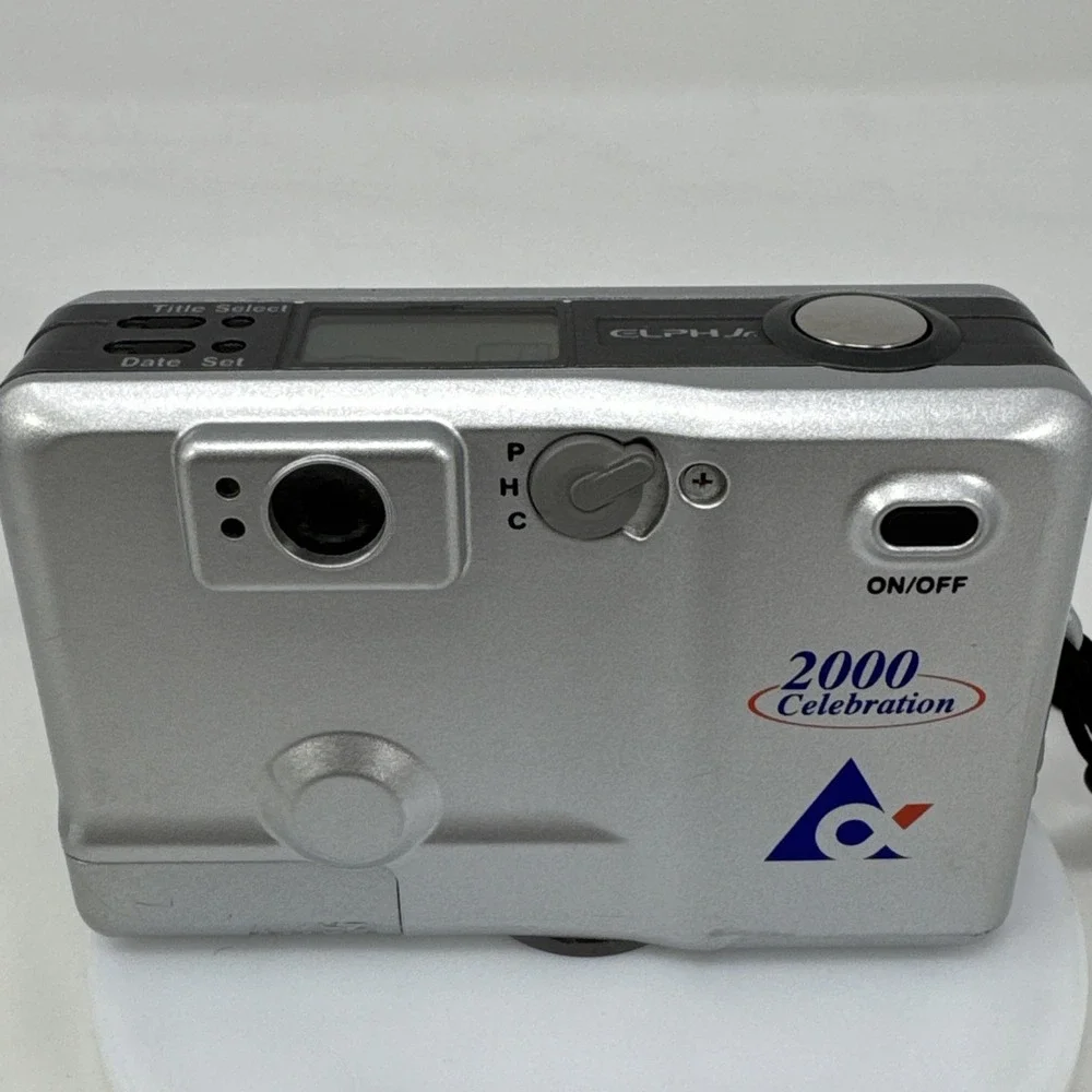 CANON Elph Jr. APS Film Camera, 26mm‎ f2.8 Wide Angle Lens, Silver w/ Case WORKS